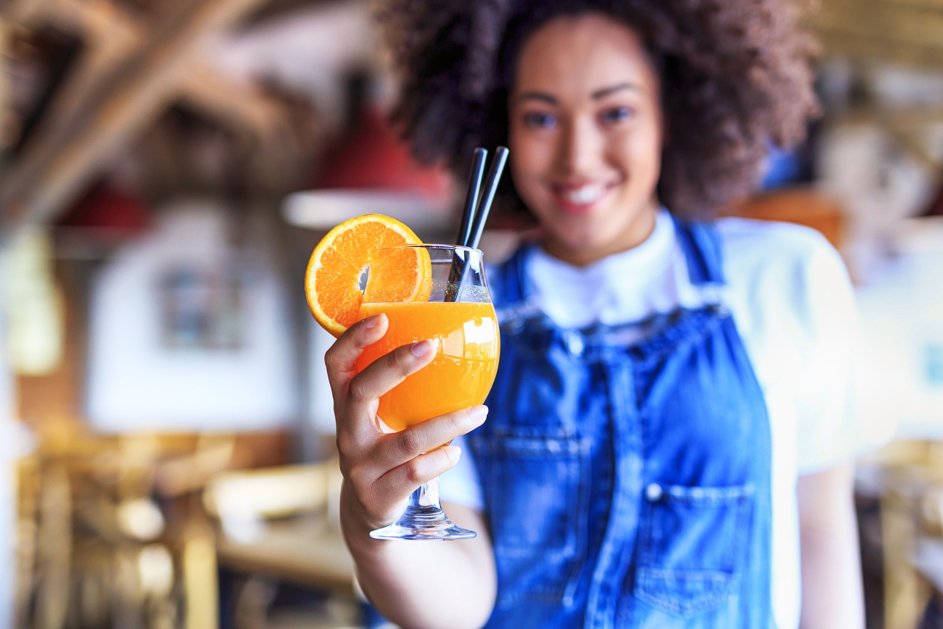 African woman drinking orange juice